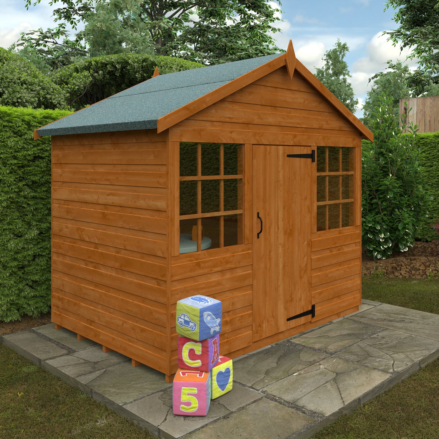 Little Haven wooden children’s playhouse with green roof and Georgian windows on stone patio surrounded by greenery