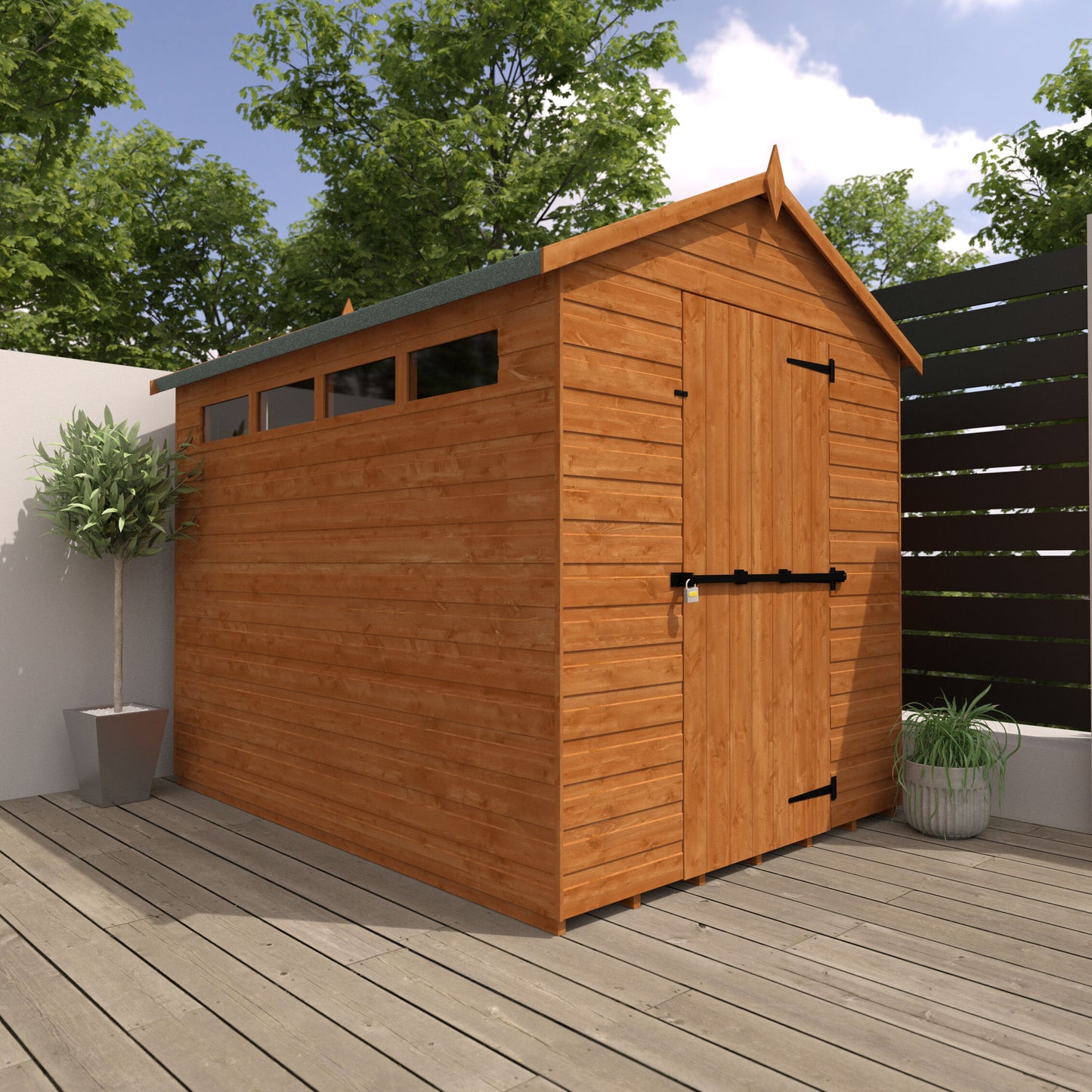 Vanguard wooden garden shed with slanted roof, door and windows, on a wooden deck with plants and trees in the background